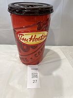 Front view of ceramic Tim Hortons cookie jar shaped like a coffee cup.