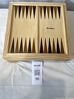 Closed wooden multi-game board with backgammon layout on lid and Tim Hortons logo