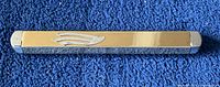 Front view of the mezuzah showing gold plated center with silver plated ends and symbolic design.