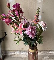 Artificial flower sticks arranged in a vase (vase not included in sale) shown against a beige wall background.