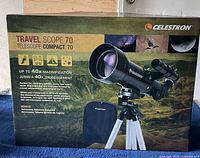 Box of Celestron Travel Scope 70 telescope showing product details and magnification capabilities.