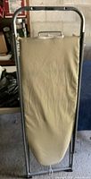 Front view of the Polder ironing board with beige padded cover and metal frame