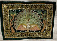 Full view of the rectangular fabric wall hanging with a peacock and ornate border design.