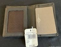 Open view of wallet showing card slots and ID window with original tag attached showing $55 price.