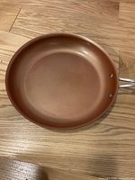 Top view of the copper-colored fry pan showing the smooth interior surface and round shape.