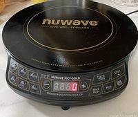 Top front view of the black Nuwave induction cooktop showing controls and digital display.