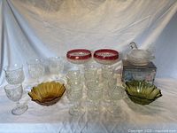 Full lot photo showing all glassware items including bowls, compotes, glasses, goblets, and the hen on a nest figurine with its box.