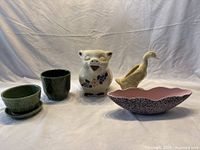 Overview of Kenwood oval bowl, pig pitcher, duck planter, tropical green jardiniere, and green pot with saucer.