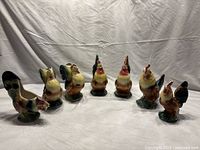 Seven hand-painted Royal Copley art pottery roosters and hens including vases and planters.