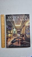 Front cover of the book showing title and a hallway interior design photo along with a ruler for scale.