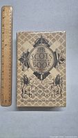 Front cover of 'The Scots Book of Lore & Folklore' showing title, author, decorative artwork and ruler for scale.