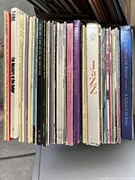 Upright stack of album spines showing jazz and Disney titles