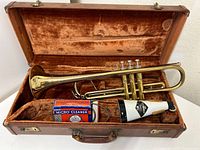 Pan-American trumpet in brown velvet-lined case with mute and micro cleaner included.