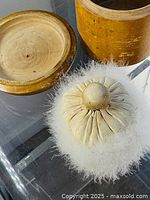 Box open showing interior wood and powder puff