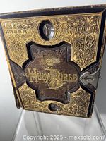 Front cover showing ornate gilt and embossed design with central recessed panel and clasp hardware