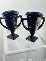 Front view of both vases showing form and relief design