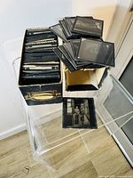 Open box with stack of lantern slides visible