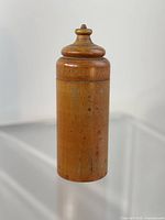 One turned wood cylindrical container with lid in place