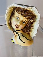 Front three-quarter view of ceramic lady head vase
