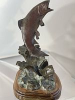 Front angled view of bronze sockeye salmon statue on oak base