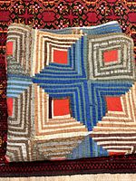 Folded quilt showing log cabin pattern and colors