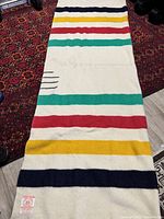 Full view of Hudson's Bay wool blanket showing stripes and size