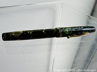 Full view of marbled green Parkette fountain pen with cap on