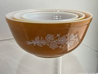 Three nested Butterfly Gold bowls showing exterior pattern