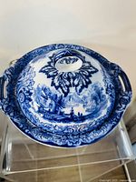 Top view of covered bowl showing Geneva pattern and handles