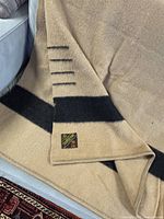 Close-up of blanket end showing four point stripes and label position