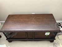 Top view of the outside of the vintage cedar chest showing scratches and carved edges