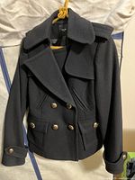 Front view of navy blue Smythe wool blend jacket showing double-breasted button front, lapel collar, epaulets, and flap pockets.