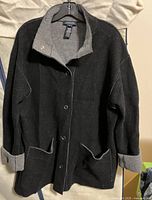 Front view of black Jones New York Signature jacket with grey collar and cuffs, button closure.