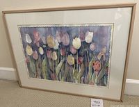 Full view of the framed watercolor painting showing tulips in various colors with a light wood frame and white matting.