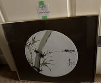 Full view of framed square artwork with bamboo and cicada motif with tag showing dimensions 24.25 x 20.25 inches