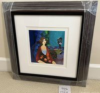 Front view of wrapped framed artwork showing dark wood frame and white mat.