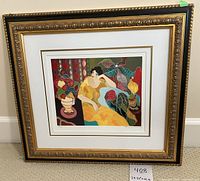 Front view of the framed print leaning against a wall on carpet.