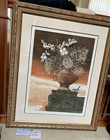 Full view of the framed lithograph art piece showing the vase filled with flowers and birds set against a background of brown and beige tones.