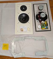 Front view of one Linn Sekrit LS6000 speaker with grill removed, showing woofer, tweeter, and mounting frame.