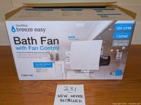 Front side of the DewStop Breeze Easy Bath Fan box showing model F300-1W and key product features such as 100 CFM airflow, 25 watts power usage, humidity sensing fan control, and quiet sound 1 SONE.