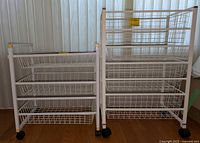 Front view of two white wire rack drawer units side by side on a wood floor, taller Elfa brand unit on right, shorter unit on left