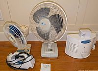 Small white fan, large Lord Sears fan, and BioZone Scientific 1000 air purifier shown together on wooden surface.