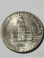 Silver-toned commemorative half dollar coin showing Independence Hall, mint condition
