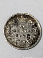 Obverse of 1871 Canadian 10 cents coin showing crown and wreath design with denomination and date.