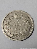 Reverse side of the 1899 Canada 5 cent coin showing denomination, year, and wreath design with crown.