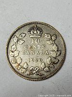 Obverse side of the 1920 Canadian silver dime showing the value and date with maple leaf motif.