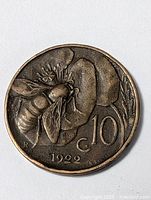 Photo showing the near mint condition of the 1922 Italian bumblebee 10 centesimi coin, highlighting the bee, flower, denomination, and date details.