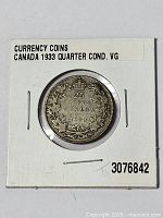 Photo of the 1933 Canadian 25 cent silver coin in protective holder showing the reverse side with denomination and date, labeled 'Currency Coins Canada 1933 Quarter Cond. VG'.