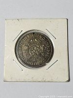 1944 silver florin coin in a square white cardboard holder, showing detailed engraving and date.