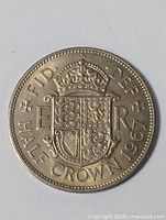 Front side of the 1967 English half crown coin showing the crowned shield of the Royal Arms and coin inscriptions.